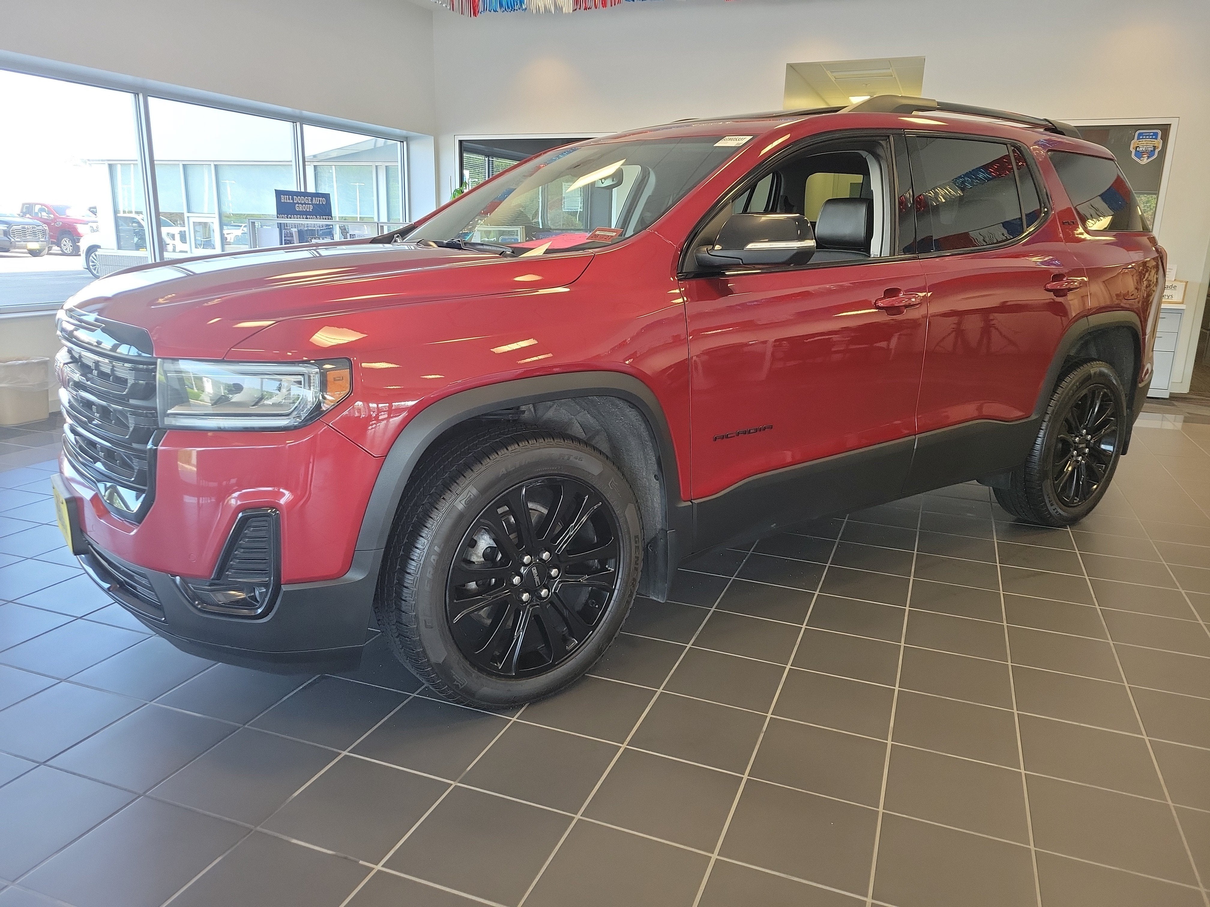 2023 GMC Acadia SLT in Volcanic Red Tintcoat — front three-quarter view