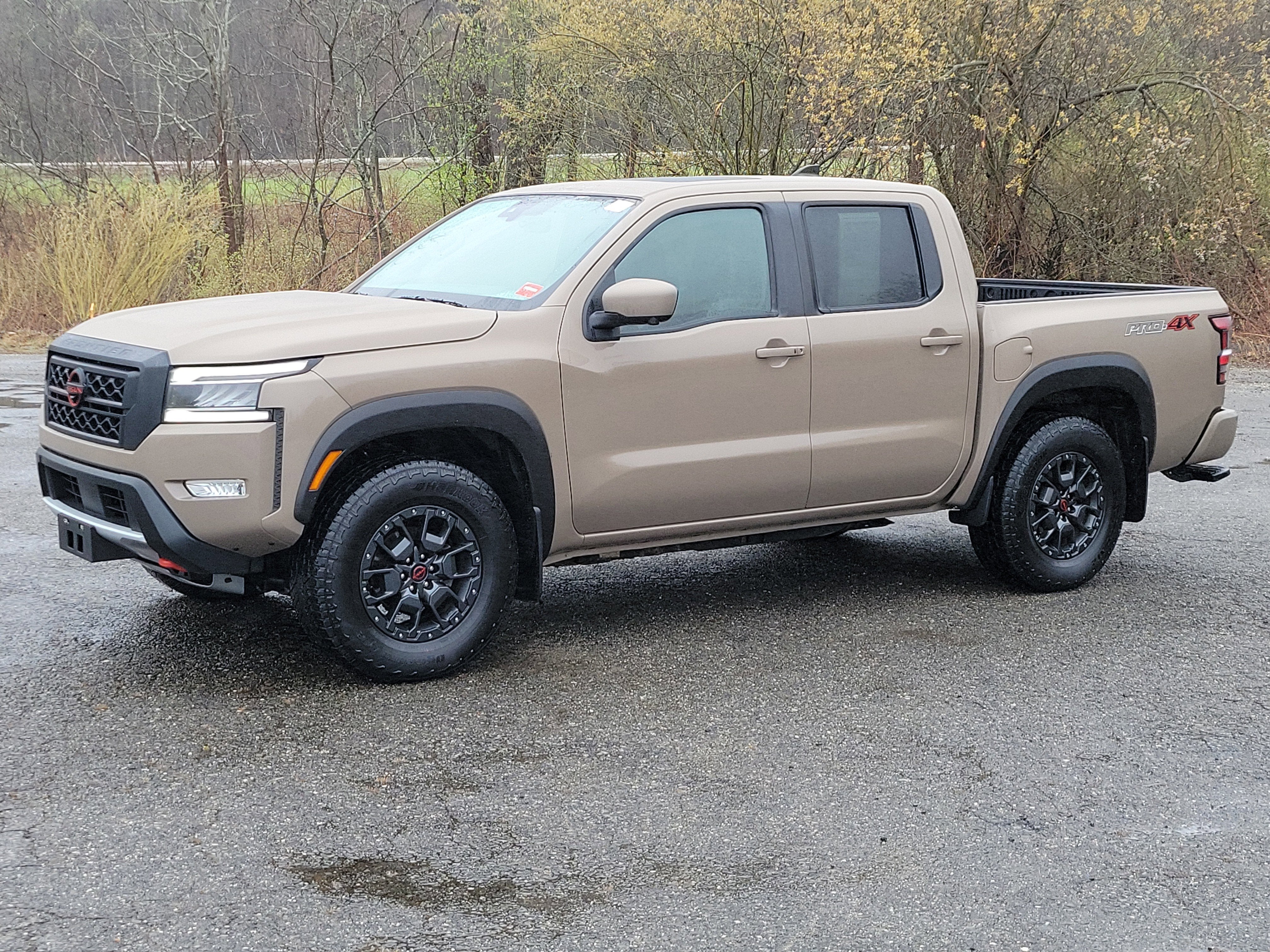 2023 Nissan Frontier Crew Cab PRO-4X 4x4 in Beige — front three-quarter view